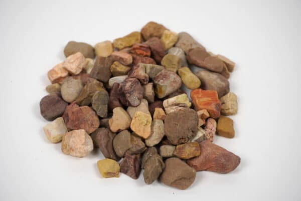 Large Apache stones in shades of brown, red, yellow, and beige, used for landscaping and decorative outdoor projects in Texas.