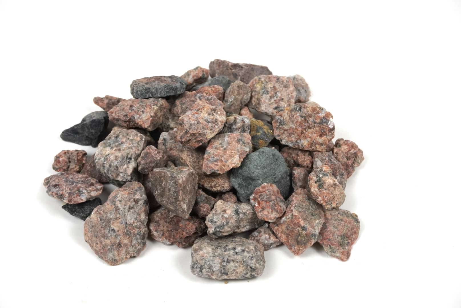 Where to Find Commercial Stone Suppliers in DFW 3 1-inch gray granite stones with mixed mineral colors including pink, black, and white, used for landscaping and construction in Texas.