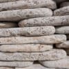 Silver Crazy Paver stones in light beige and gray shades, arranged in a stacked pattern for landscaping and outdoor design in Texas.