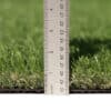 Emerald Green Turf 76 roll with vibrant synthetic grass and black woven backing, used for landscaping and sports applications in Texas.