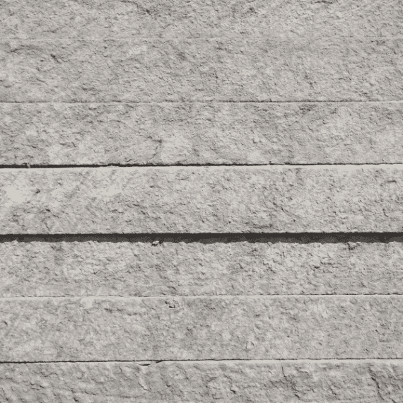 Grey Slab 1 Grey stone slab with layered horizontal texture, used for architectural walls and landscaping in Texas.